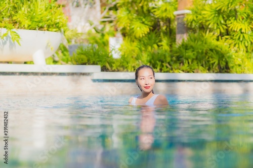 Portrait beautiful young asian woman relax smile leisure around outdoor swimming pool in hotel resort © siraphol