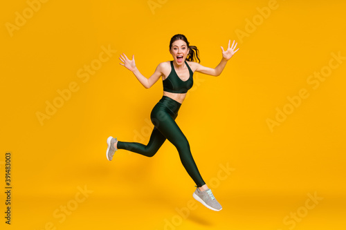 Fototapeta Naklejka Na Ścianę i Meble -  Profile photo of sportive lady jump high training marathon race competitive wear sports suit shoes isolated yellow color background