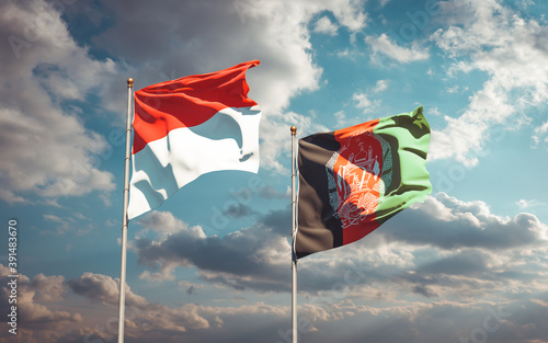 Beautiful national state flags of Indonesia and Afghanistan together at the sky background. 3D artwork concept.