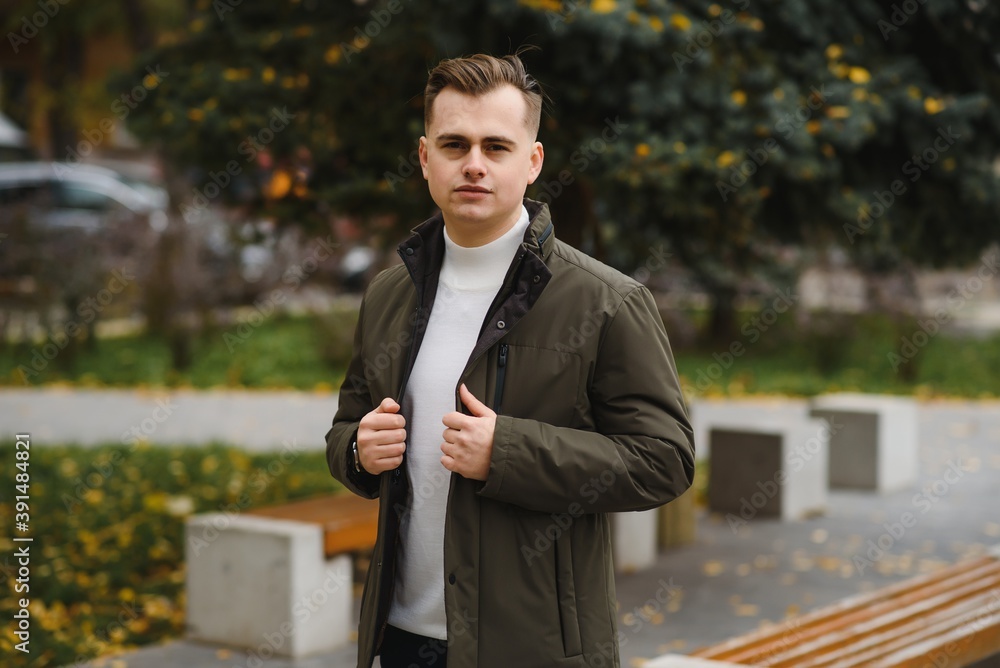 Portrait of a young handsome man, model of fashion, with modern hairstyle in urban background, wearing casual clothes. Portrait of a young handsome man, model of fashion, with modern hairstyle in urban background, wearing casual clothes.