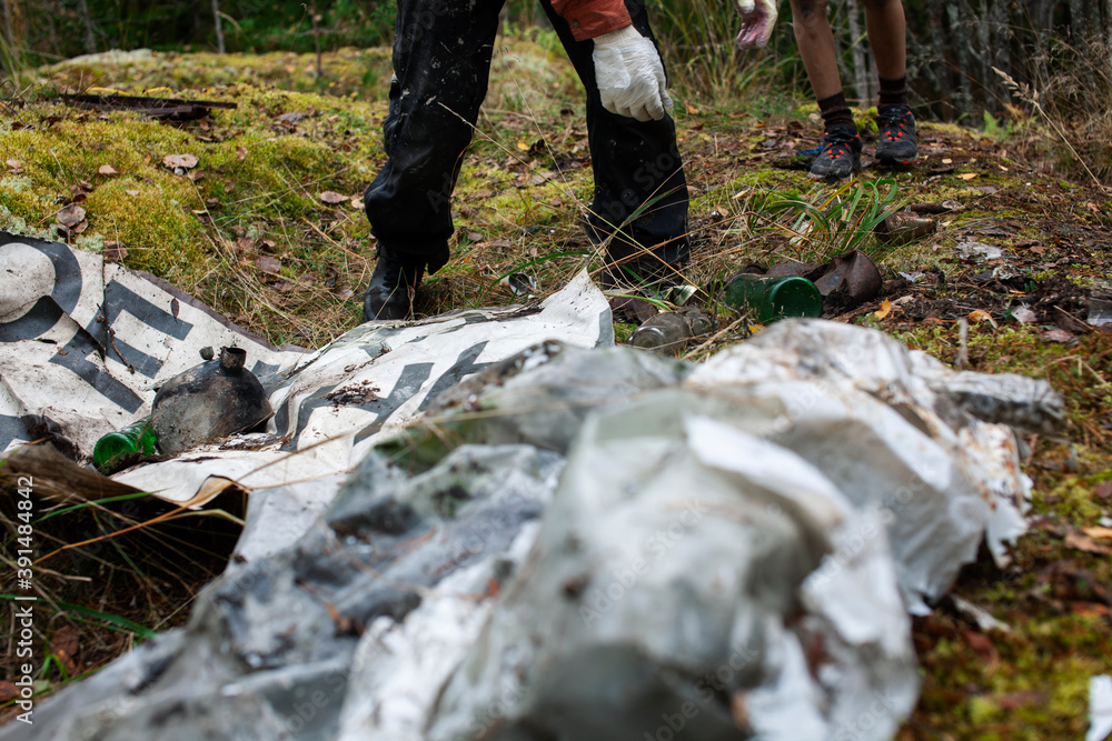 big amount of trash in forest, family father and son picking garbage away, global environment issues big amount of trash in forest, family father and son picking garbage away, global environment issues