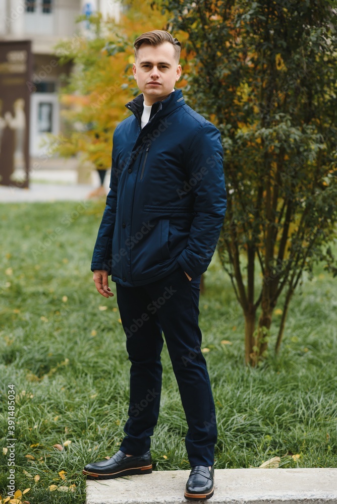 Portrait of a stylish man with a beard dressed in a coat, outdoors Portrait of a stylish man with a beard dressed in a coat, outdoors