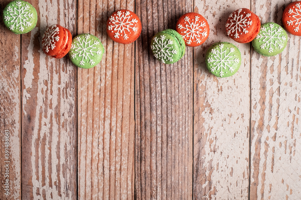 Christmas macaron border on a weathered wooden table background. Iced with snowflakes these macaron macaroons are red and green and leave copy space and room for text. Christmas macaron border on a weathered wooden table background. Iced with snowflakes these macaron macaroons are red and green and leave copy space and room for text.
