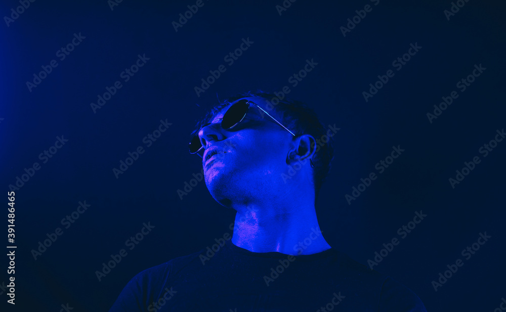 Male portrait. Neon light studio close-up portrait of serious man model. Model. Male portrait. Neon light studio close-up portrait of serious man model. Model.