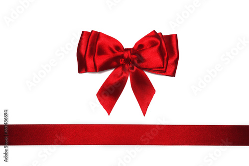 Red satin bow and ribbon on white background