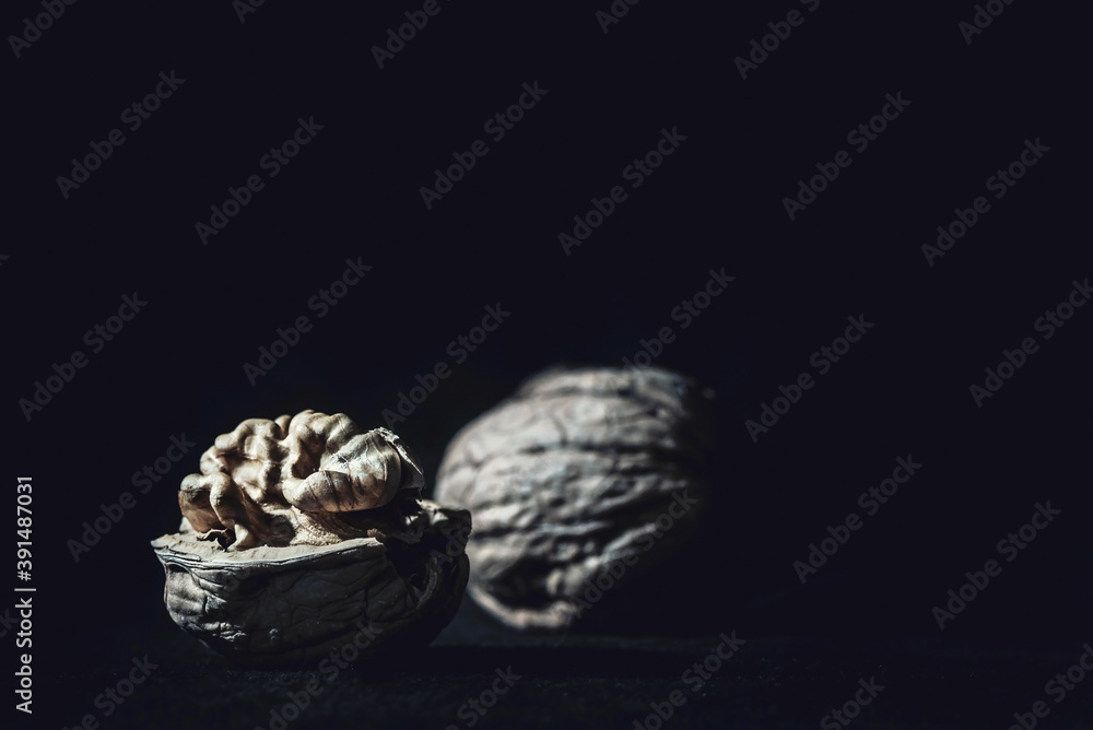 Two walnuts on a black background, close up ,macro photography Two walnuts on a black background, close up ,macro photography