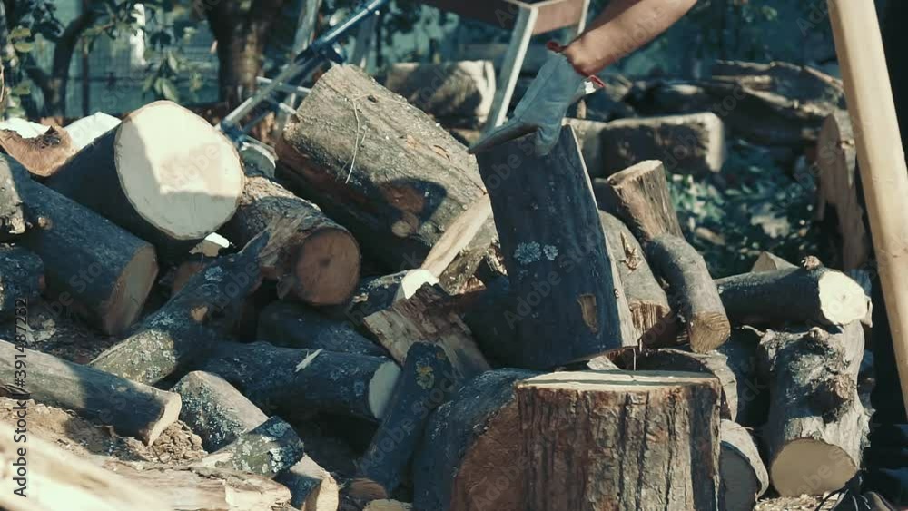Men chopping firewood for heating at home. Men chopping firewood for heating at home.