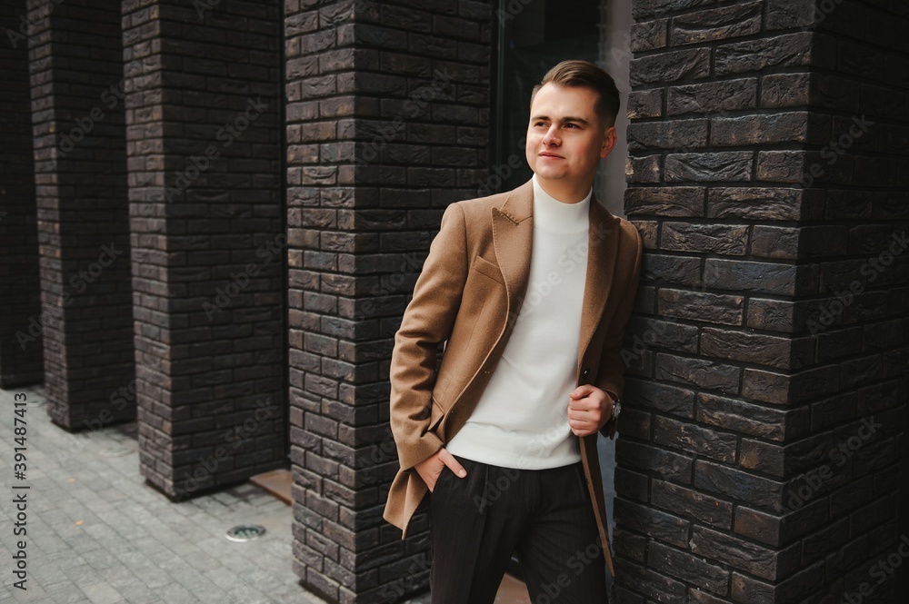 Portrait of a stylish man with a beard dressed in a coat, outdoors Portrait of a stylish man with a beard dressed in a coat, outdoors