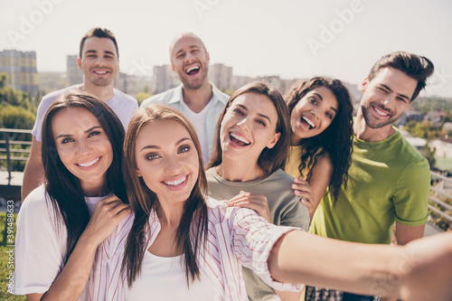 Photo of optimistic pretty girls handsome guys doing selfie have fun party on roof terrace outside © deagreez