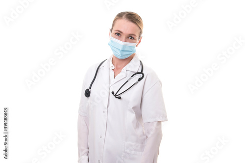 Young doctor in white uniform and stethoscope wearing mask on isolated background