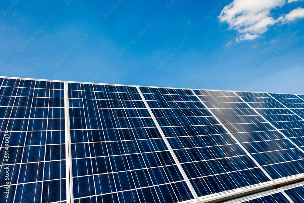 A solar panel with blue sky and small cloud. A solar panel with blue sky and small cloud.