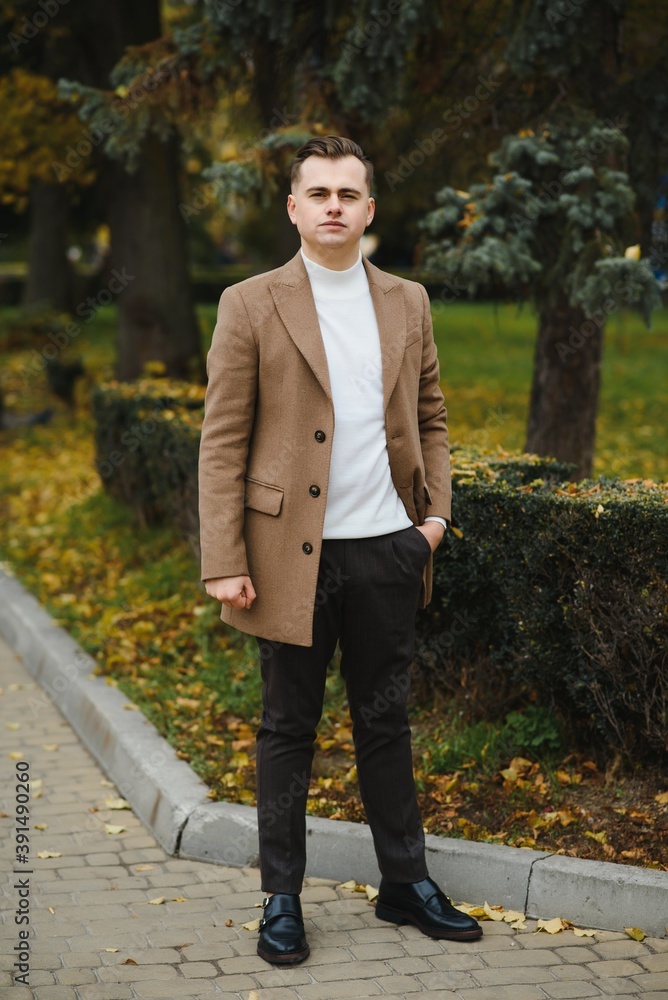 Portrait of a stylish man with a beard dressed in a coat, outdoors Portrait of a stylish man with a beard dressed in a coat, outdoors