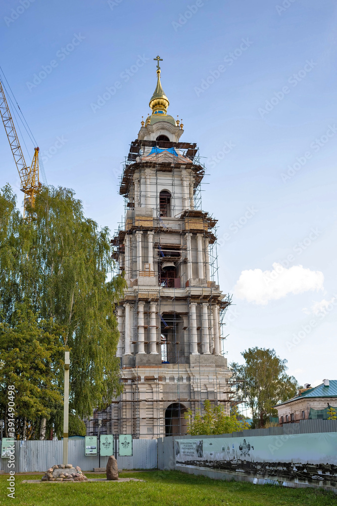Kostroma. Summer day on the Bank of the Volga. Bell tower of the restored assumption Cathedral of the Kostroma Kremlin. Kostroma. Summer day on the Bank of the Volga. Bell tower of the restored assumption Cathedral of the Kostroma Kremlin.