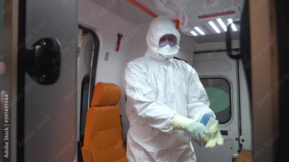 Doctors in an ambulance car in protection from covid. Doctors in an ambulance car in protection from covid.
