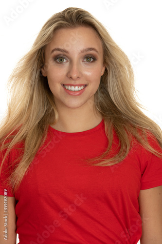 Portrait of a cute teenage girl in red tshirt over white