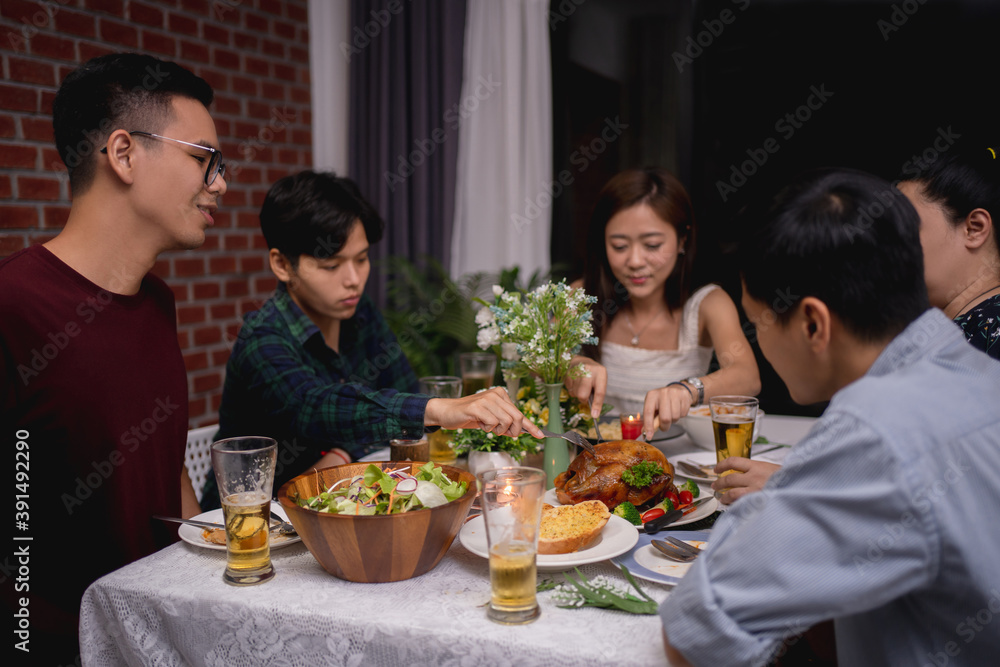 Group of Asian friends have a party and are eating at home.