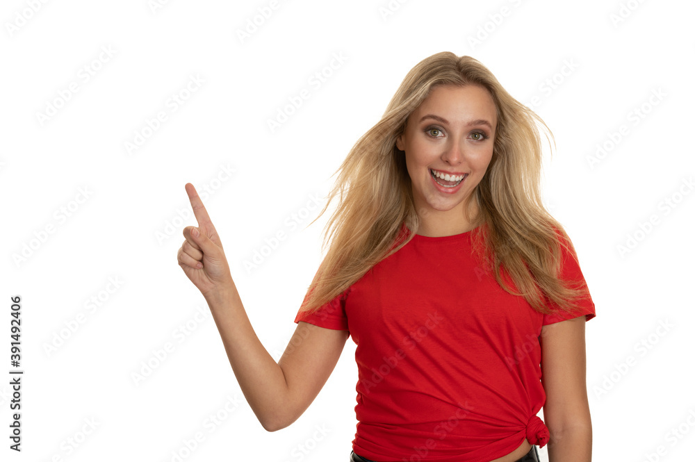 Beautiful young woman in red tshirt point in copy space Beautiful young woman in red tshirt point in copy space