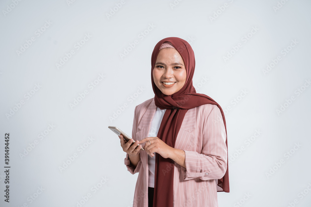Happy business muslim woman portrait using the phone on white background Happy business muslim woman portrait using the phone on white background