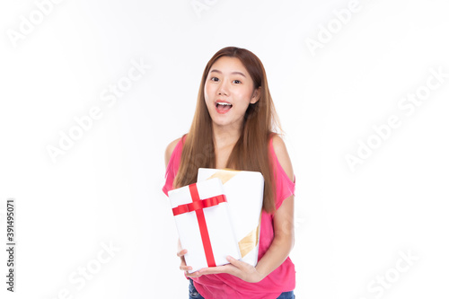 Portrait of smiling happy pretty girl hold gift box on white background.