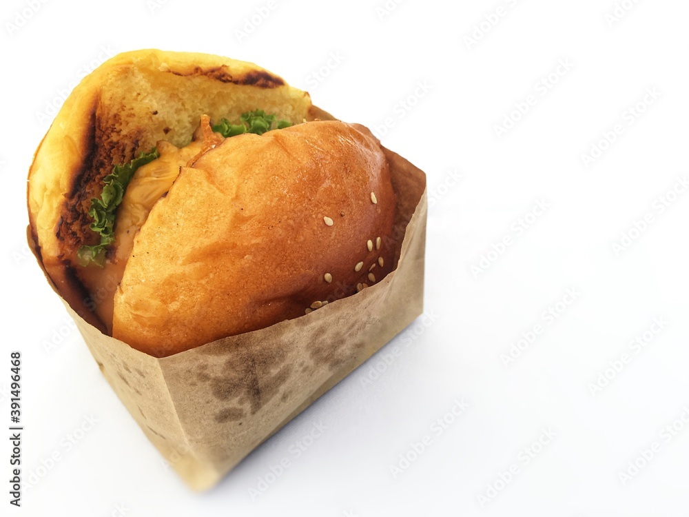 Hamburger chicken ready to eat in paper bag.