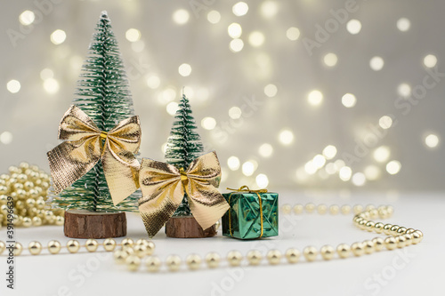 decorative Christmas trees decorated and gifts for the new year on the bokeh background, new year mood 2021