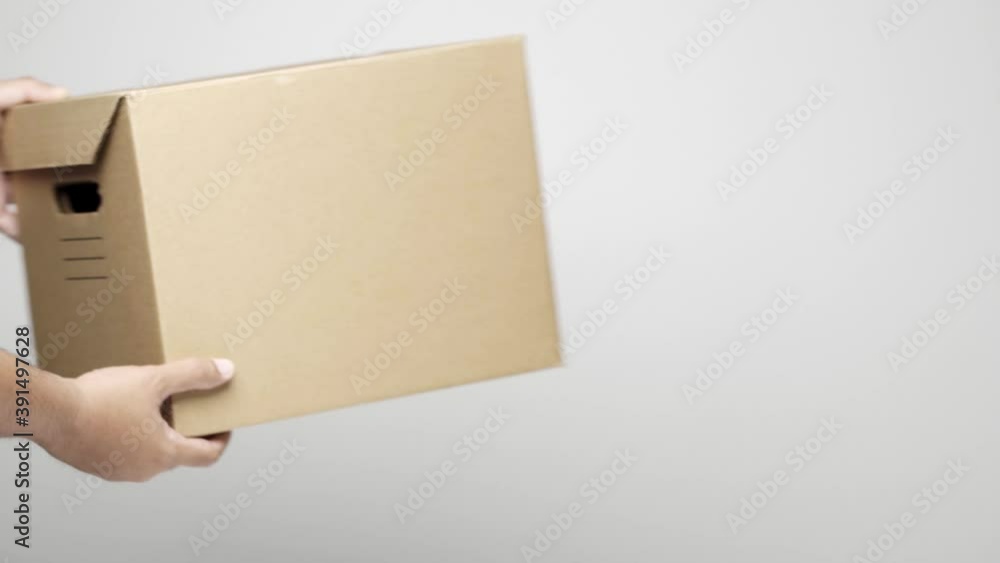 Close up male hands receive the parcel box cardboard from delivery man on isolated white background. Logistic cargo shopping online concept. 4k resolution. Close up male hands receive the parcel box cardboard from delivery man on isolated white background. Logistic cargo shopping online concept. 4k resolution.