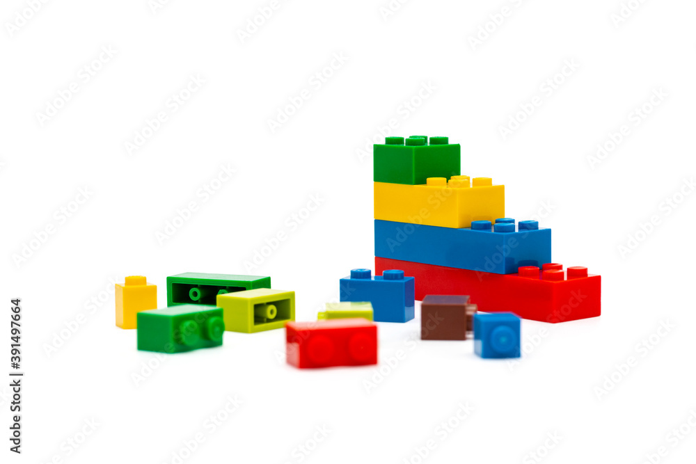 Fototapeta premium Multi-colored plastic building blocks. Toys and games. Focus in the background.