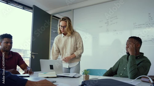 Caucasian businesswoman presenting ideas fr upcoming assignment talking in front of diverse colleagues 