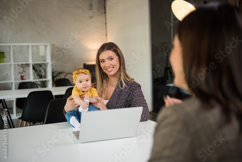 Wallpaper Mural Single mother holding her baby girl on a job interview Torontodigital.ca