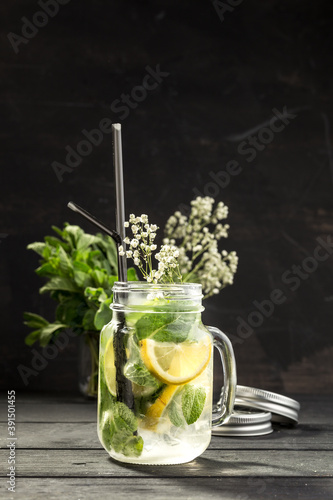mason jar Of Cold Fresh Squeezed Lemonade On the table on black background