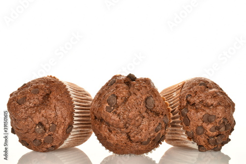 A few delicious chocolate muffins, close-up, on a white background. © Oleksandr
