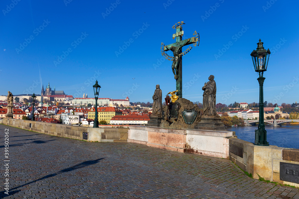 Autumn colorful Prague Lesser Town with gothic Castle from Charles Bridge with its baroque Sculpture, Czech Republic