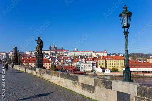 Autumn colorful Prague Lesser Town with gothic Castle from Charles Bridge with its baroque Sculpture, Czech Republic