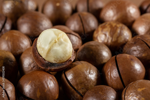 Heap of macadamia nuts as background. Food background. Close-up.