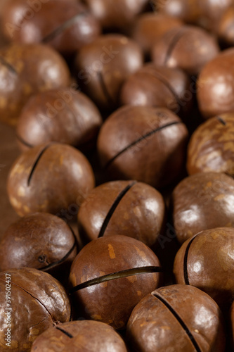 Heap of macadamia nuts as background. Food background. Close-up.