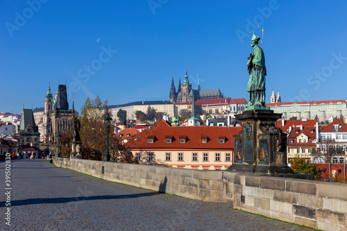 Autumn colorful Prague Lesser Town with gothic Castle from Charles Bridge with its baroque Sculpture, Czech Republic