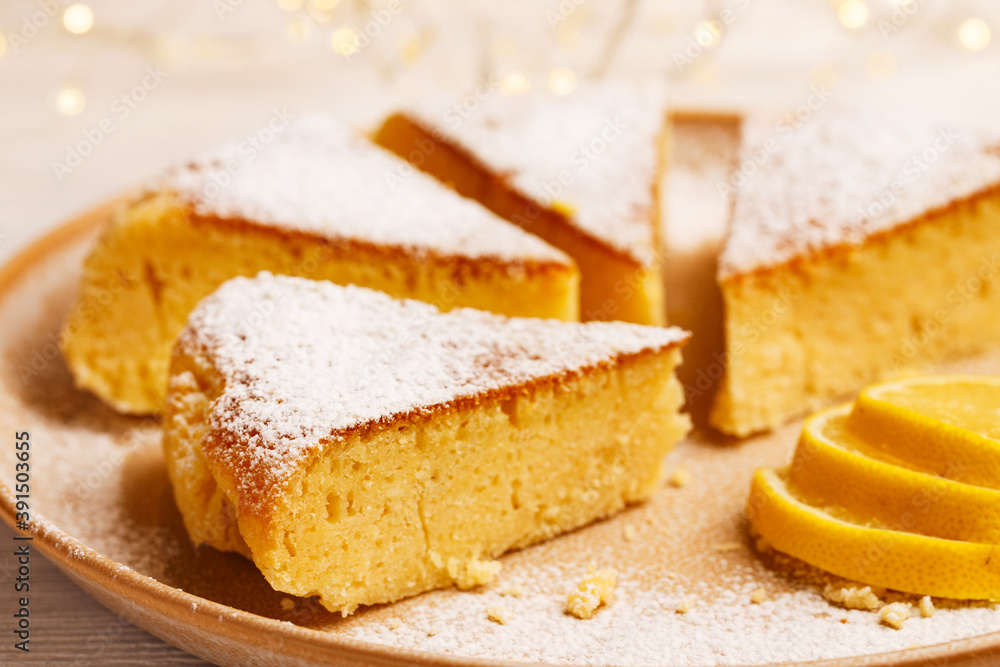 Citrus lemon cake with sugar powder on plate