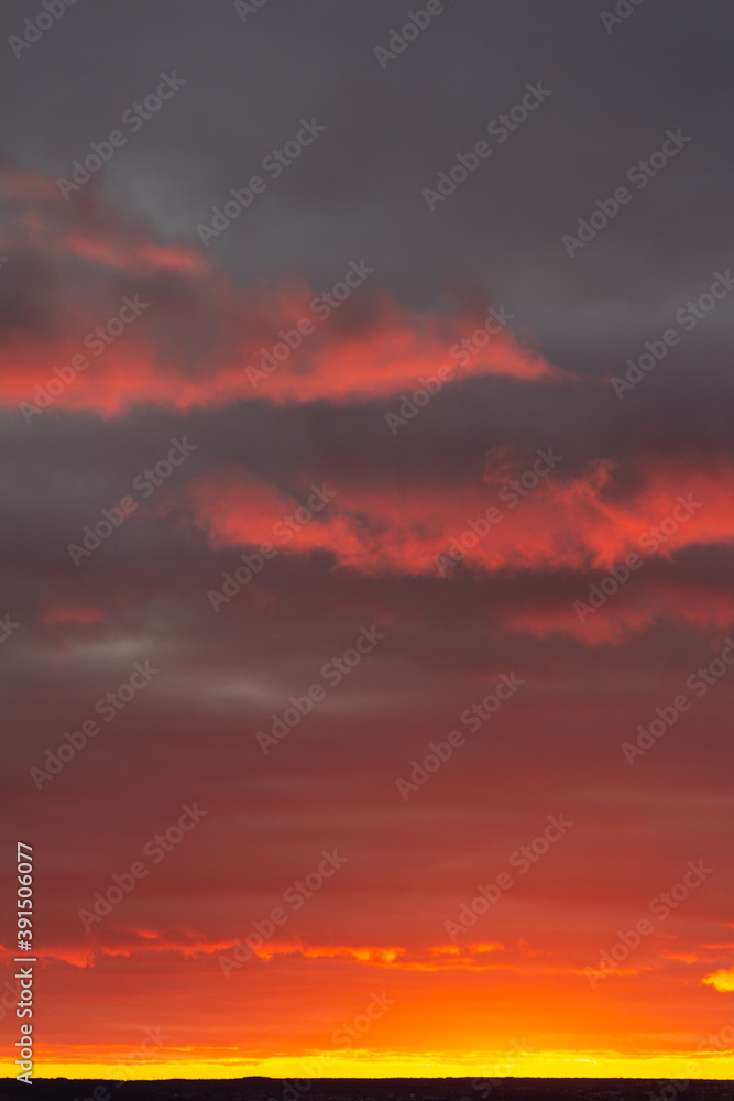 Wonderful November sunset with bright red-pink clouds on a dark gray-blue sky Wonderful November sunset with bright red-pink clouds on a dark gray-blue sky