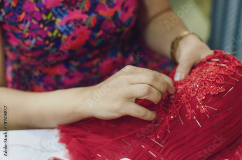 Fashion designer sews wedding dresses