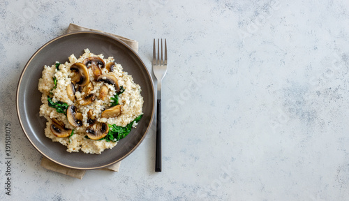 Risotto with mushrooms and spinach. Healthy food. Vegetarian food. photo