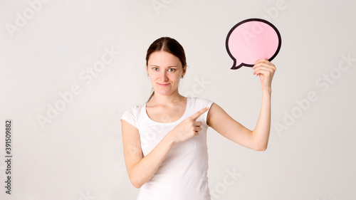 woman holding blank speech bubble