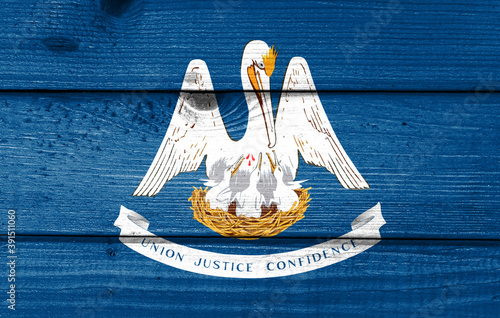 lousiana flag painted on old wood plank background. Brushed natural light knotted wooden board texture. Wooden texture background flag of lousiana