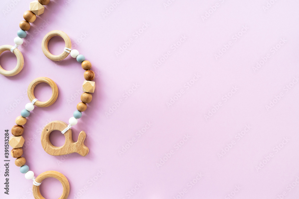 Eco-friendly wooden children's toys on a pink background, top view, flat layout, copy space. Flat composition, baby background Eco-friendly wooden children's toys on a pink background, top view, flat layout, copy space. Flat composition, baby background