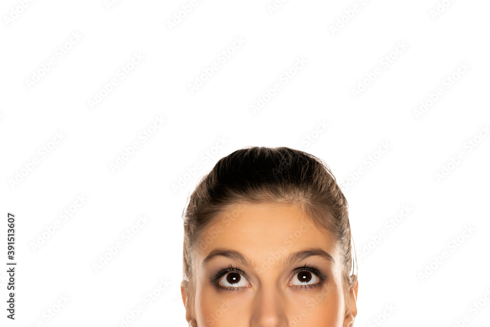 Half portrait of young puzzled woman , looking up Half portrait of young puzzled woman , looking up