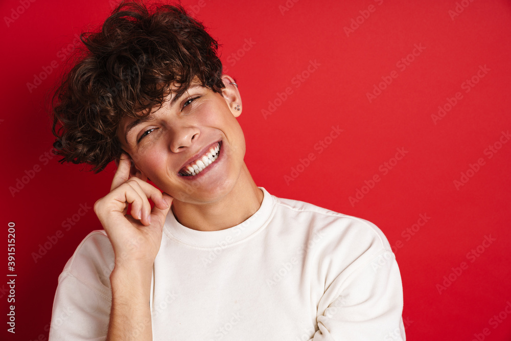Handsome cheerful guy smiling and looking at camera Handsome cheerful guy smiling and looking at camera