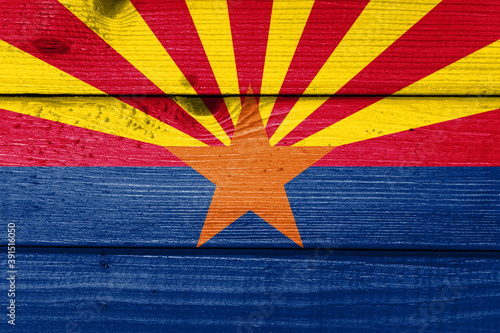 arizona flag painted on old wood plank background. Brushed natural light knotted wooden board texture. Wooden texture background flag of arizona