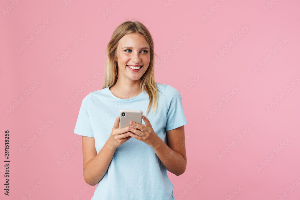 Smiling attractive young woman using mobile phone Smiling attractive young woman using mobile phone
