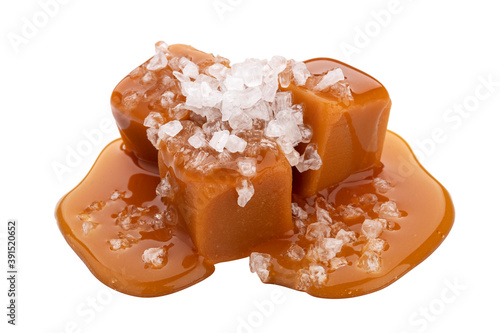 Toffee candies with caramel sauce and salt isolated on white background