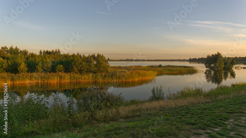 Late afternoon panoramic landscape at Pogoria IV Lake.