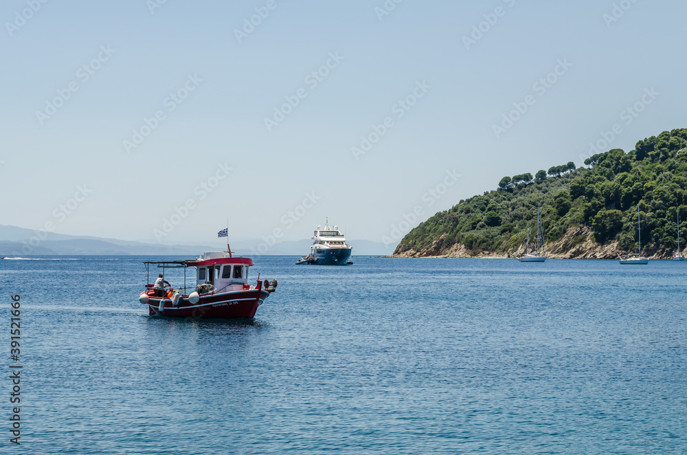 Lihada island, Greece - June 28. 2020: A boat on the sea near the island of Lihada, Greece Lihada island, Greece - June 28. 2020: A boat on the sea near the island of Lihada, Greece